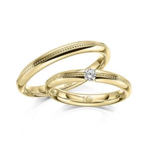 Trauringe mit Perlfuge und Brillant in Spannfassung Gelbgold